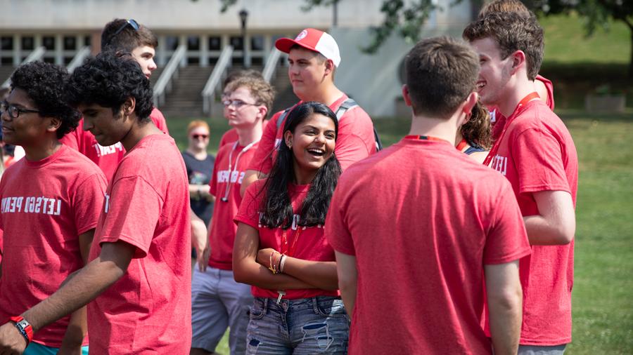 Group of students standing outside and talking