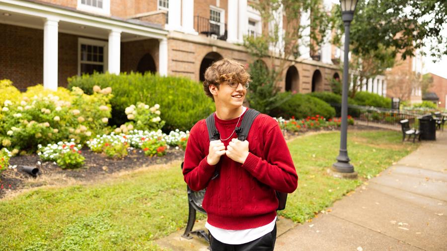 Student walking on campus with their backpack