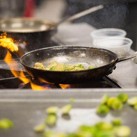 Students at Fort Campbell work on preparing meals