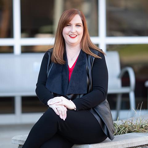 Malissa Harris poses for photo in front of Maynard math and science building