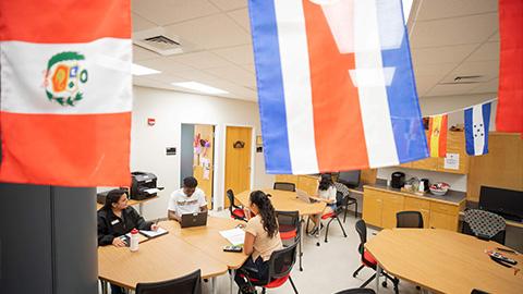 students sitting at tables in the resource center